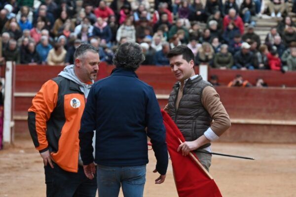 Tres hombres conversando en un evento del Carnaval del Toro
