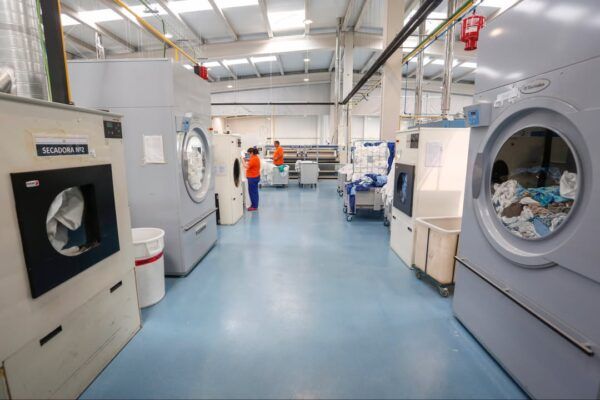 Interior de una lavandería con trabajadores realizando tareas