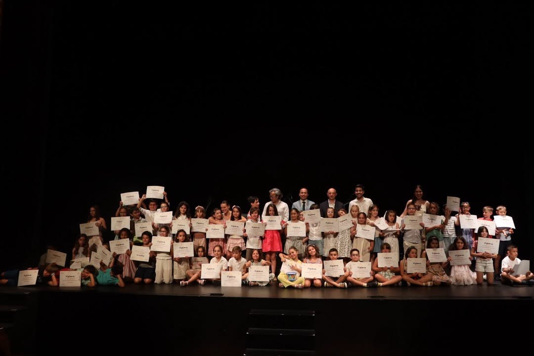Alumnos de la Escuela Municipal de Música y Danza de Salamanca sosteniendo diplomas en una ceremonia