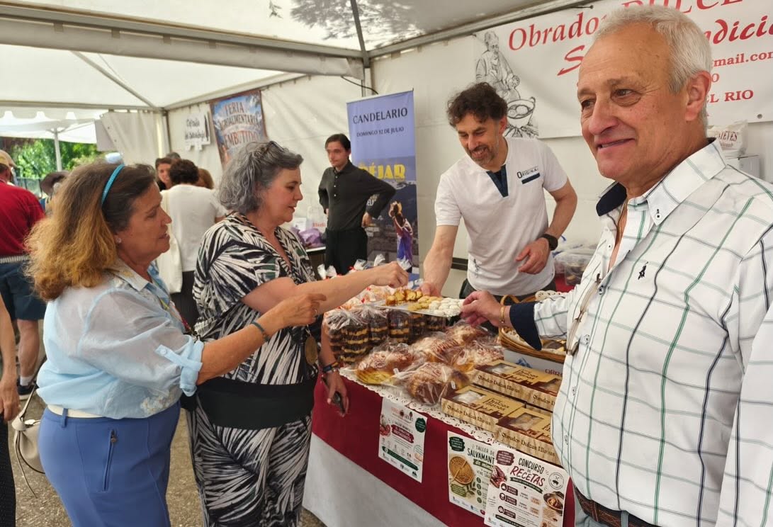 Visitantes en la II Feria Agroalimentaria de Candelario interactuando con productores locales.