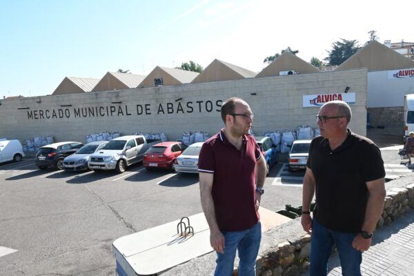 Dos hombres conversando frente al Mercado Municipal de Abastos en Ciudad Rodrigo