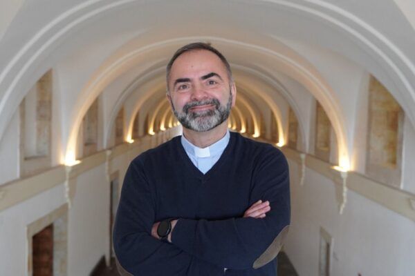 José San José Prisco sonriendo en un pasillo con arcos