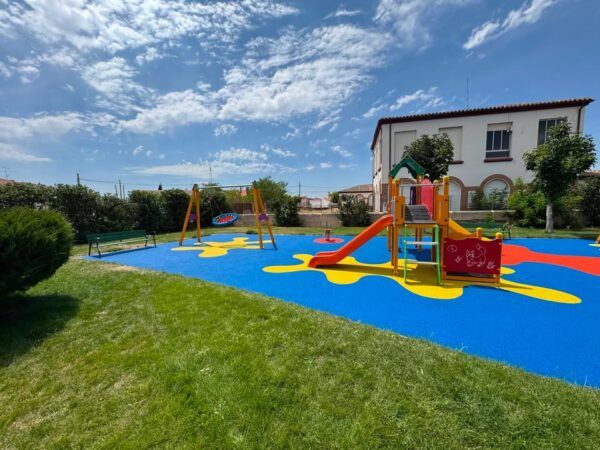 Parque municipal de Macotera con juegos infantiles y césped verde