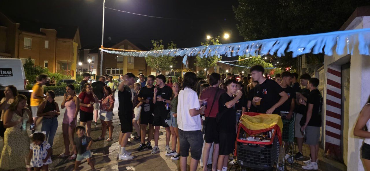 Grupo de personas celebrando bajo banderines en Villamayor