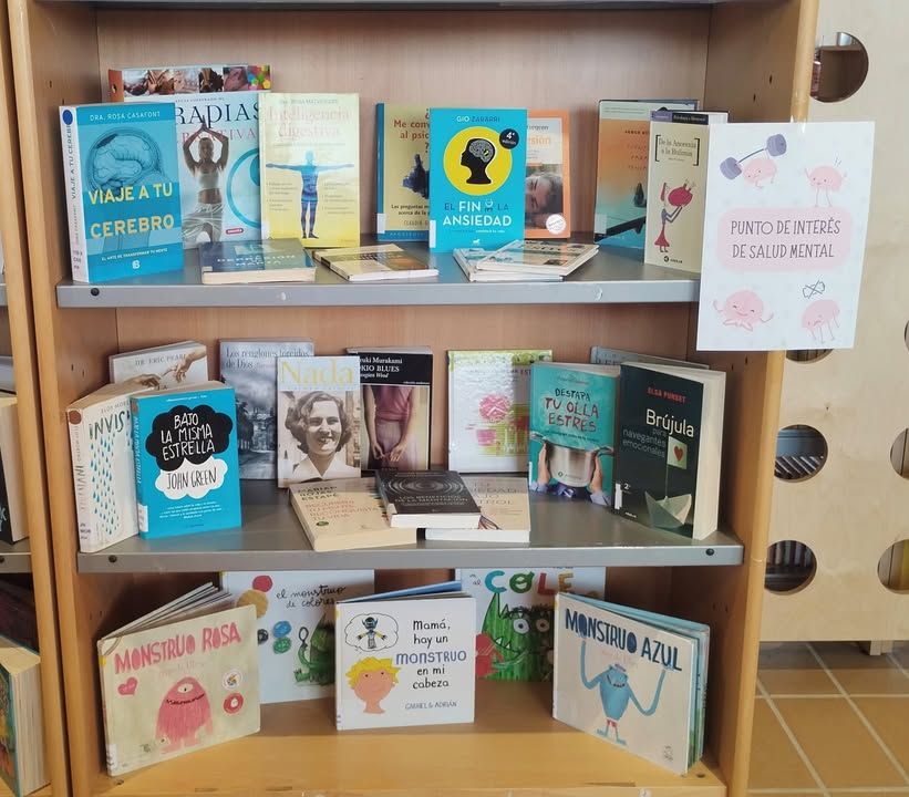 Estantería con libros sobre salud mental en la biblioteca de Carbajosa de la Sagrada