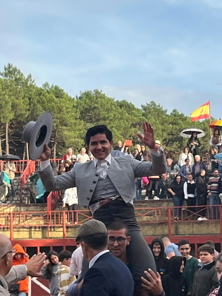 Joven torero siendo aclamado por el público tras su actuación exitosa.