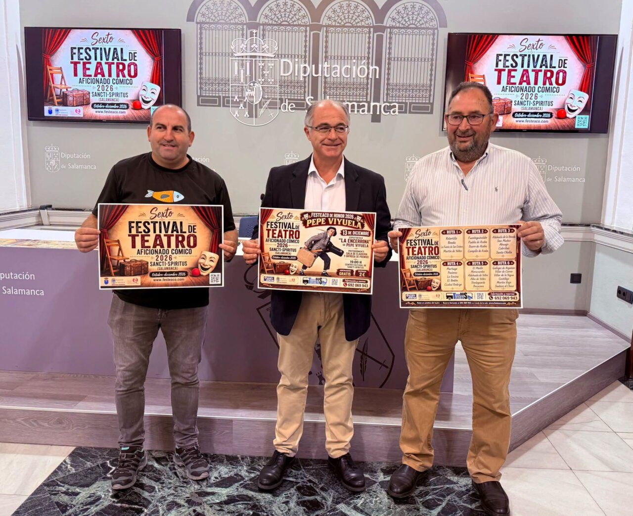 Tres hombres sostienen carteles del sexto Festival de Teatro Aficionado Cómico en Salamanca.